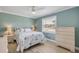Inviting bedroom with light blue walls, white trim, and wood-look floors with natural light at 2945 Juniper Dr, Edgewater, FL 32141