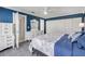 Main bedroom showcases blue accent wall, white trim, and a comfortable queen bed at 2945 Juniper Dr, Edgewater, FL 32141