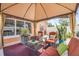 Comfortable covered patio seating area with outdoor furniture and potted plants at 2945 Juniper Dr, Edgewater, FL 32141