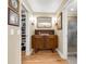 Bathroom vanity area, with vintage cabinet, hardwood floor, decor lighting and framed pictures at 3015 Dawley Ave, Orlando, FL 32806