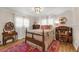 Cozy bedroom with natural light, hardwood floors, crown molding, and decorated with antique furniture at 3015 Dawley Ave, Orlando, FL 32806