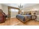 Charming bedroom displays hardwood floors, a decorative chandelier, and harmonizing decor at 3015 Dawley Ave, Orlando, FL 32806