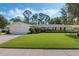 Charming single-story home featuring a lush front lawn, manicured landscaping, and a two-car garage at 3015 Dawley Ave, Orlando, FL 32806