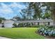 Beautiful home featuring a well-maintained lawn, colorful flower beds, and a classic design at 3015 Dawley Ave, Orlando, FL 32806