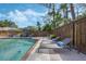 Relaxing pool area with lounge chairs and privacy fence offers a serene outdoor living space at 3015 Dawley Ave, Orlando, FL 32806