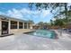 Backyard pool area with patio, pool chairs, and a wooden fence provides a space for summer fun at 3015 Dawley Ave, Orlando, FL 32806
