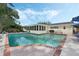 In-ground pool with brick trim offers an outdoor oasis perfect for entertaining or relaxing at 3015 Dawley Ave, Orlando, FL 32806