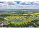 Scenic aerial view of the golf course and surrounding landscape with homes nearby at 3312 Cordgrass Pl, St Cloud, FL 34773