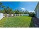 Well-maintained backyard with lush green grass, privacy fence, and mature landscaping at 3312 Cordgrass Pl, St Cloud, FL 34773