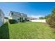Expansive backyard with lush green grass and a white fence for privacy at 3312 Cordgrass Pl, St Cloud, FL 34773