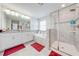 Bathroom featuring double vanity, soaking tub, and glass-enclosed shower at 3312 Cordgrass Pl, St Cloud, FL 34773