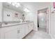 Bright bathroom features a double vanity with granite countertop and a separate shower and tub at 3312 Cordgrass Pl, St Cloud, FL 34773