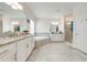 Spacious bathroom featuring double sinks, a shower and a large bathtub at 3312 Cordgrass Pl, St Cloud, FL 34773