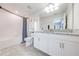 Well-lit bathroom featuring granite counters, white cabinets, and tile flooring at 3312 Cordgrass Pl, St Cloud, FL 34773