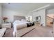 Spacious main bedroom with plush carpet, tray ceiling, and comfortable king-size bed at 3312 Cordgrass Pl, St Cloud, FL 34773