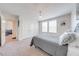 Bright bedroom featuring plush carpet, modern lighting, and a neutral color palette at 3312 Cordgrass Pl, St Cloud, FL 34773