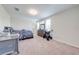 Comfortable bedroom with neutral carpet, a dresser and a large window at 3312 Cordgrass Pl, St Cloud, FL 34773