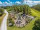 Aerial shot of the fenced-in community garden, with plots and a gazebo set in a lush green setting at 3312 Cordgrass Pl, St Cloud, FL 34773