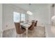 Dining room with modern light fixture and a table set for a dinner at 3312 Cordgrass Pl, St Cloud, FL 34773