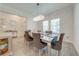 Elegant dining room with a modern chandelier, large windows, and seating for six at 3312 Cordgrass Pl, St Cloud, FL 34773
