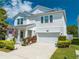 Charming two-story home with landscaped yard and a two-car garage on a sunny day at 3312 Cordgrass Pl, St Cloud, FL 34773