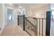 Hallway with carpet and a metal safety gate for stairs at 3312 Cordgrass Pl, St Cloud, FL 34773