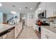 Bright kitchen with granite countertops, stainless steel appliances, and a stylish mosaic tile backsplash at 3312 Cordgrass Pl, St Cloud, FL 34773