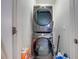 Modern laundry room featuring a stacked washer and dryer unit at 3312 Cordgrass Pl, St Cloud, FL 34773