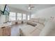 Comfortable living room with large sectional couch, ceiling fan, and tile floors at 3312 Cordgrass Pl, St Cloud, FL 34773