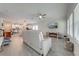 Open concept living room features modern lighting, tile floors, and comfortable sectional couch at 3312 Cordgrass Pl, St Cloud, FL 34773