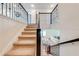Carpeted staircase with dark wood railing leading to an open living area at 3312 Cordgrass Pl, St Cloud, FL 34773