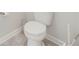Bathroom featuring toilet with modern design and gray floor tiles at 3312 Cordgrass Pl, St Cloud, FL 34773