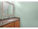 Powder room features granite countertop with oval sink and wood vanity at 3331 Morelyn Crest Cir, Orlando, FL 32828