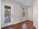 Bonus room with wood floors, a window, and an exterior door to a screened patio at 3331 Morelyn Crest Cir, Orlando, FL 32828