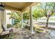 Charming covered front porch with stone flooring and rocking chairs, perfect for enjoying the neighborhood views at 3331 Morelyn Crest Cir, Orlando, FL 32828