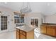 Well-lit kitchen featuring an island, tile floors, and sliding doors with backyard views at 3331 Morelyn Crest Cir, Orlando, FL 32828