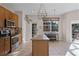 Sunlit kitchen includes an island, tile flooring, stainless steel appliances, and a breakfast table at 3331 Morelyn Crest Cir, Orlando, FL 32828
