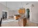 Bright eat-in kitchen features tile flooring, an island, natural wood cabinetry, and stainless appliances at 3331 Morelyn Crest Cir, Orlando, FL 32828