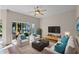 Comfortable living room with natural light, ceiling fan, and sliding glass doors to outside at 3331 Morelyn Crest Cir, Orlando, FL 32828