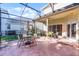 Enclosed patio area with ample seating, dining, and view of the backyard at 3331 Morelyn Crest Cir, Orlando, FL 32828