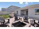 This backyard includes an outdoor kitchen, fire pit, dining, and lounge area at 3529 Yarian Dr, Haines City, FL 33844