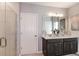 Bathroom featuring double vanity, frameless shower and a door into the private toilet area at 3529 Yarian Dr, Haines City, FL 33844