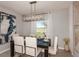Elegant dining room with modern lighting, stylish furniture, and bright natural light at 3529 Yarian Dr, Haines City, FL 33844