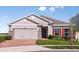 Charming single-story home with a two-car garage, stone accents, and a well-manicured lawn at 3529 Yarian Dr, Haines City, FL 33844
