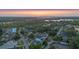 Sunset aerial view of a neighborhood near a lake, showcasing the home's location and surrounding beauty at 3608 Dubsdread Cir, Orlando, FL 32804