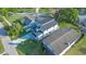 Picture-perfect aerial view of a modern home with fresh landscaping and a long driveway at 3608 Dubsdread Cir, Orlando, FL 32804