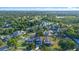 Stunning aerial view of a modern two-story home with lush landscaping and a long driveway on a beautiful lot at 3608 Dubsdread Cir, Orlando, FL 32804