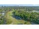 Scenic aerial view of a lush golf course community with ponds, sand traps, and manicured fairways at 3608 Dubsdread Cir, Orlando, FL 32804