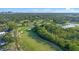 Sweeping aerial view of the community golf course with immaculate greens, sand traps, and winding cart paths at 3608 Dubsdread Cir, Orlando, FL 32804