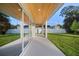 Inviting back patio with a wood-paneled ceiling and sliding glass doors, seamlessly blending indoor and outdoor living at 3608 Dubsdread Cir, Orlando, FL 32804